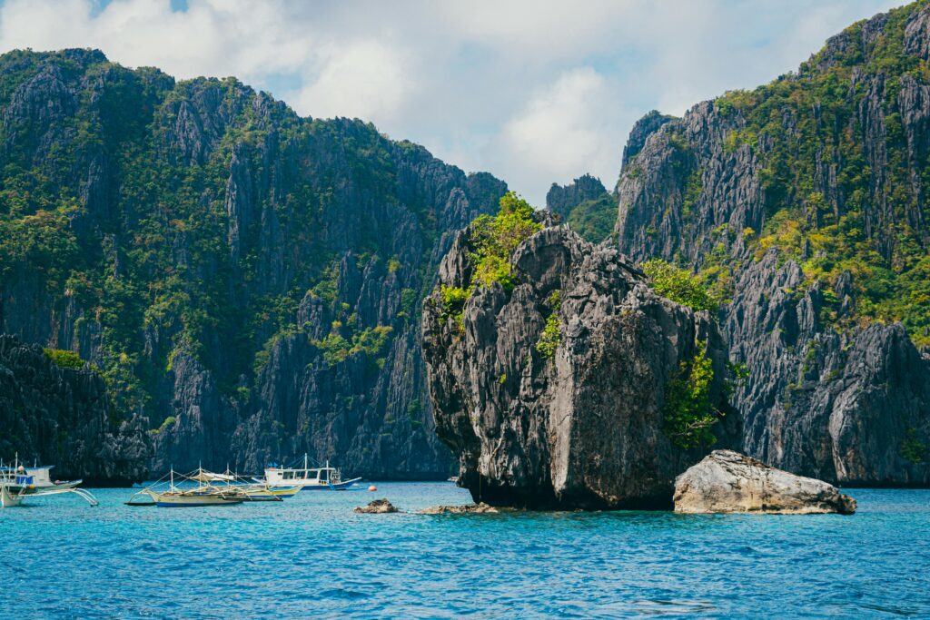 Breathtaking view of tropical rock formations and boats in Palawan