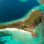 View of Malcapuya Island featuring a pristine white sand beach near Coron Palawan Philippines.