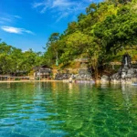 A visitor soaking in the natural saltwater pool at Maquinit Hot Spring, Coron, Palawan
