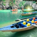 Paddle boats carrying tourists near the cave entrance of the Underground River, a top thing on what to do in Puerto Princesa Palawan.